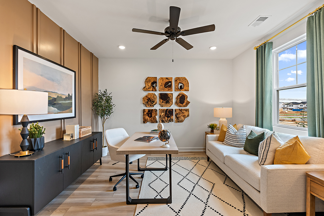 A living room with a fan and a couch.