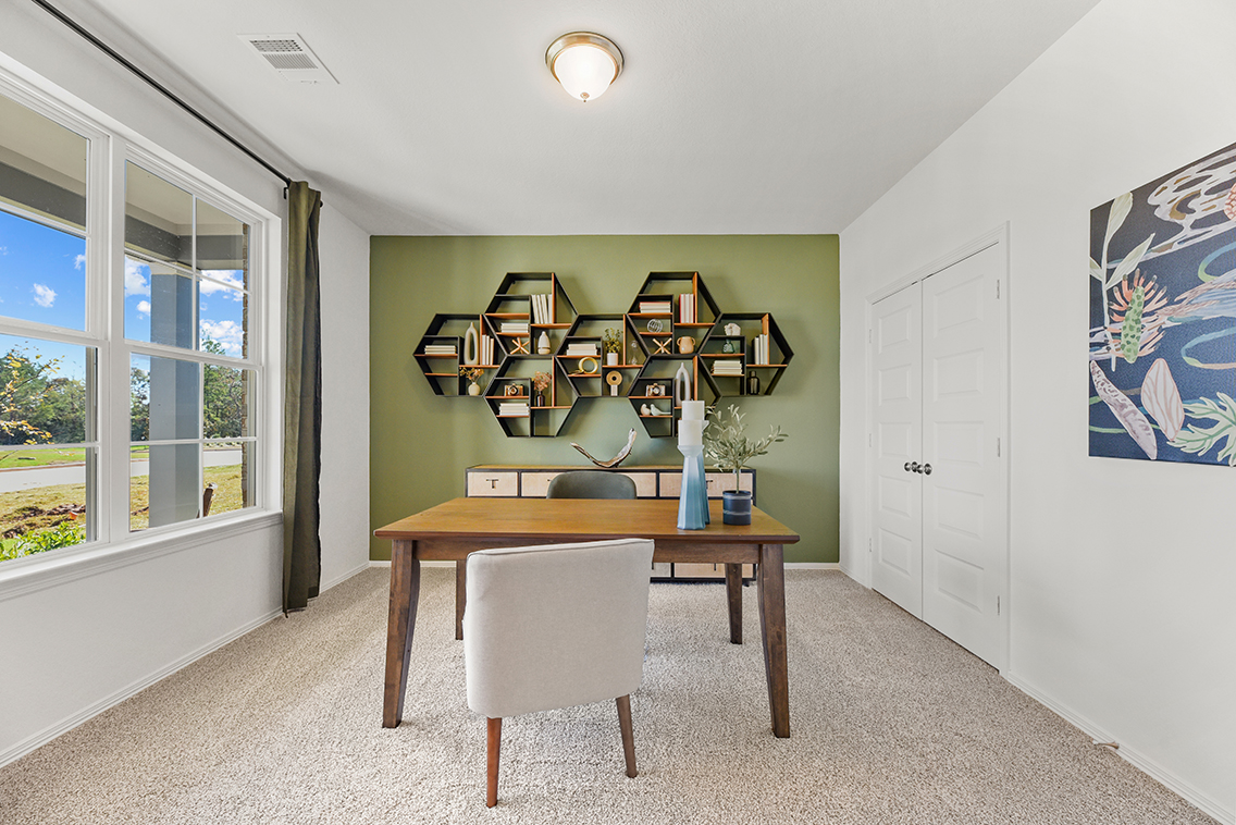 A room with a table and chairs.