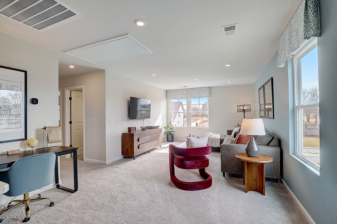 A living room with a tv and chairs.