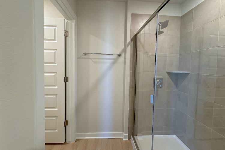 A shower with a glass door.