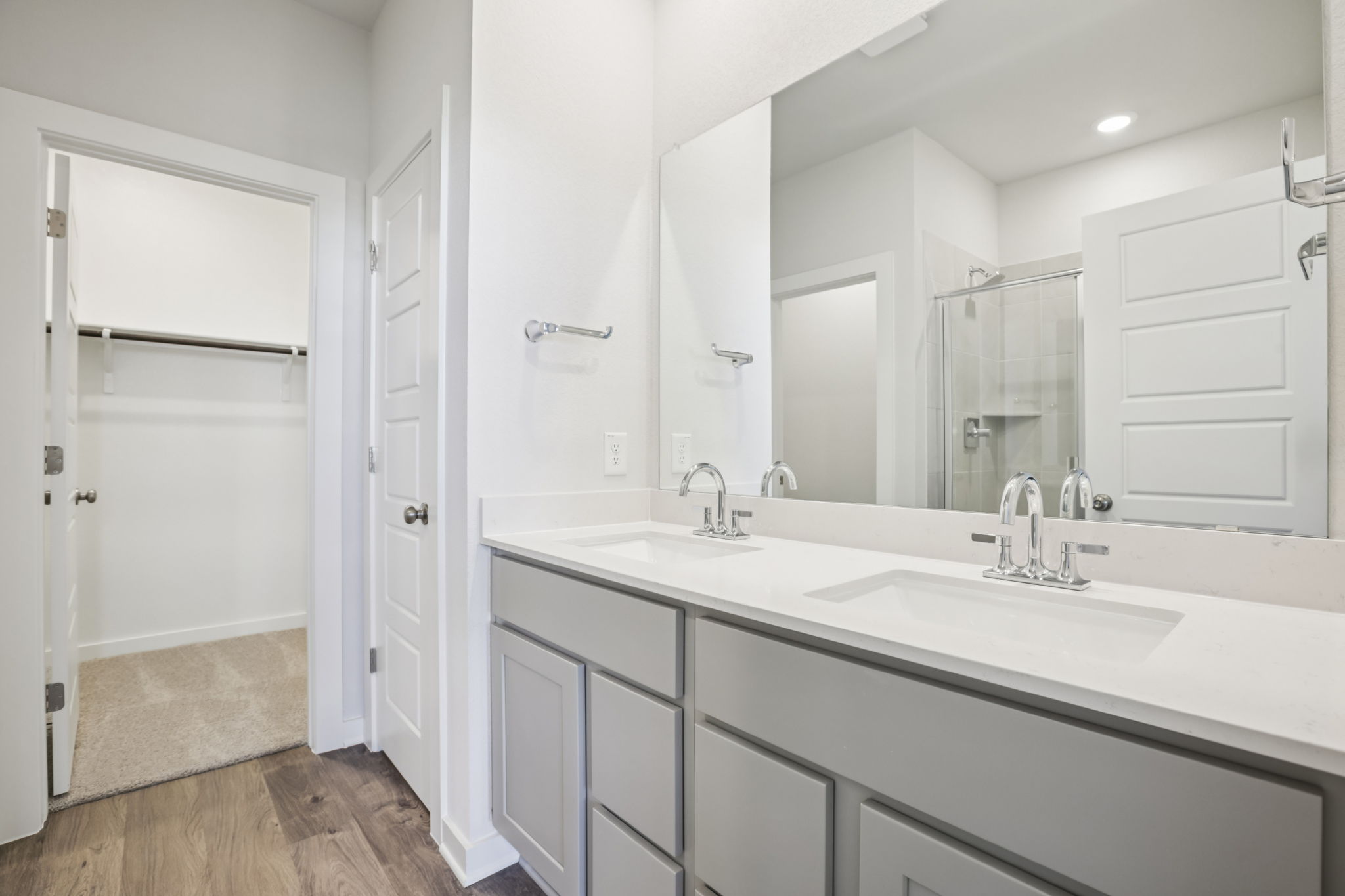 A bathroom with white cabinets.