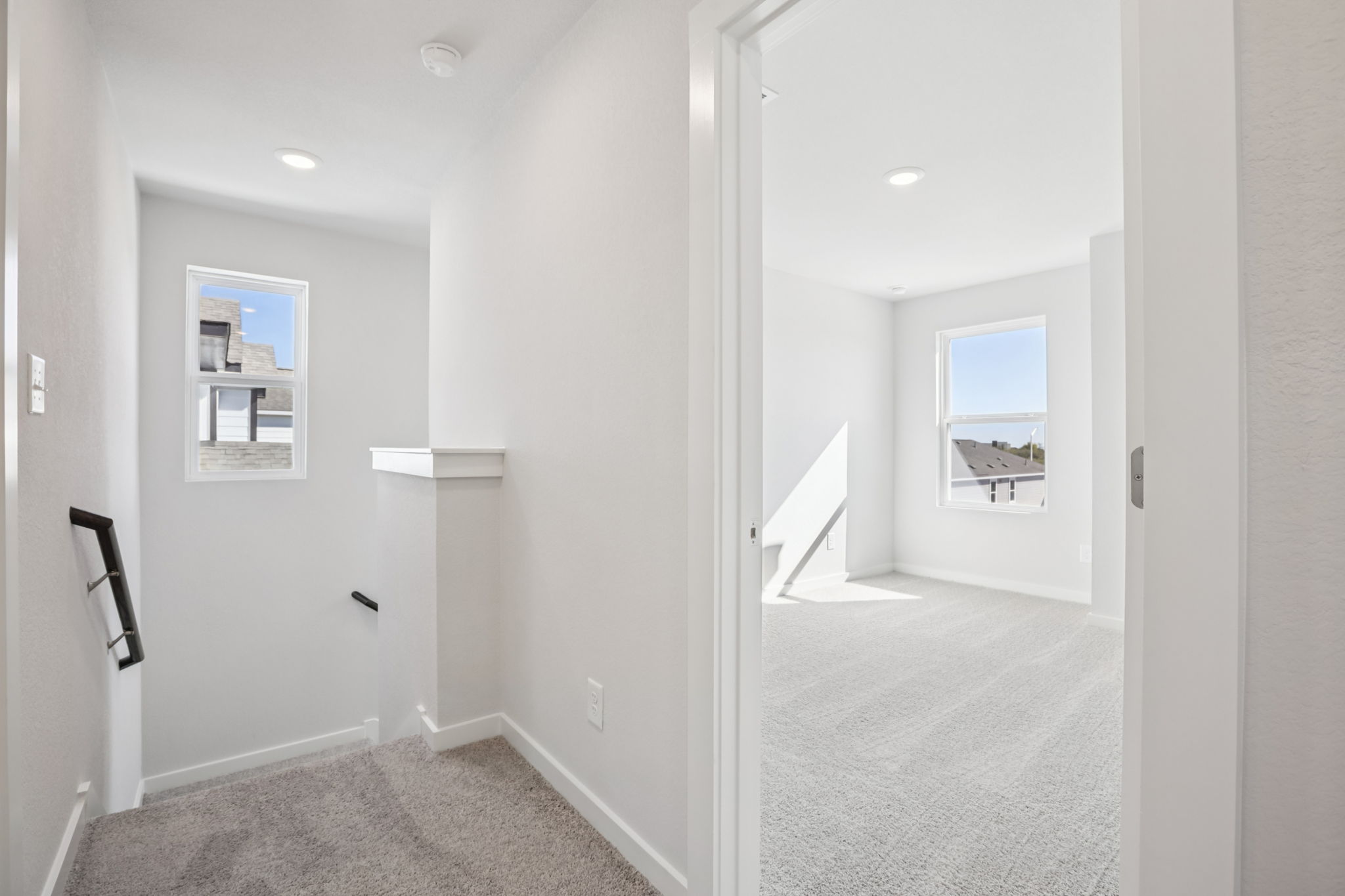 A hallway with white walls.