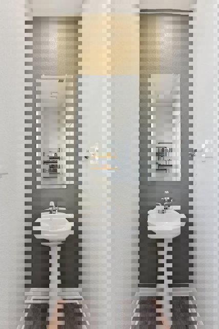 A bathroom with a mirror and sink.