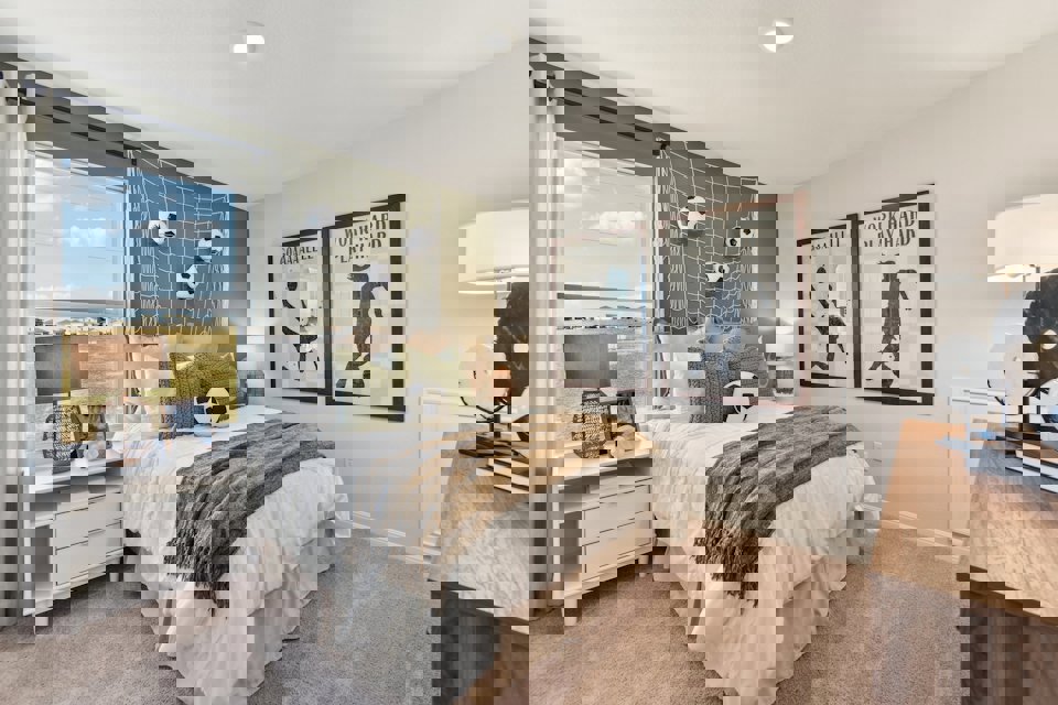 A bedroom with a large window.