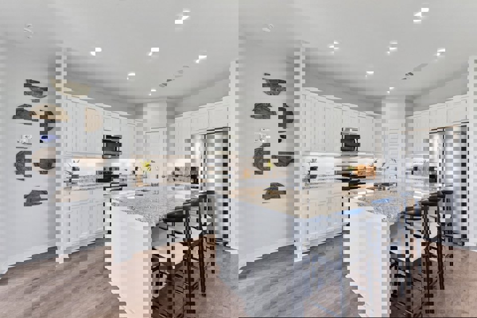 A kitchen with white cabinets.