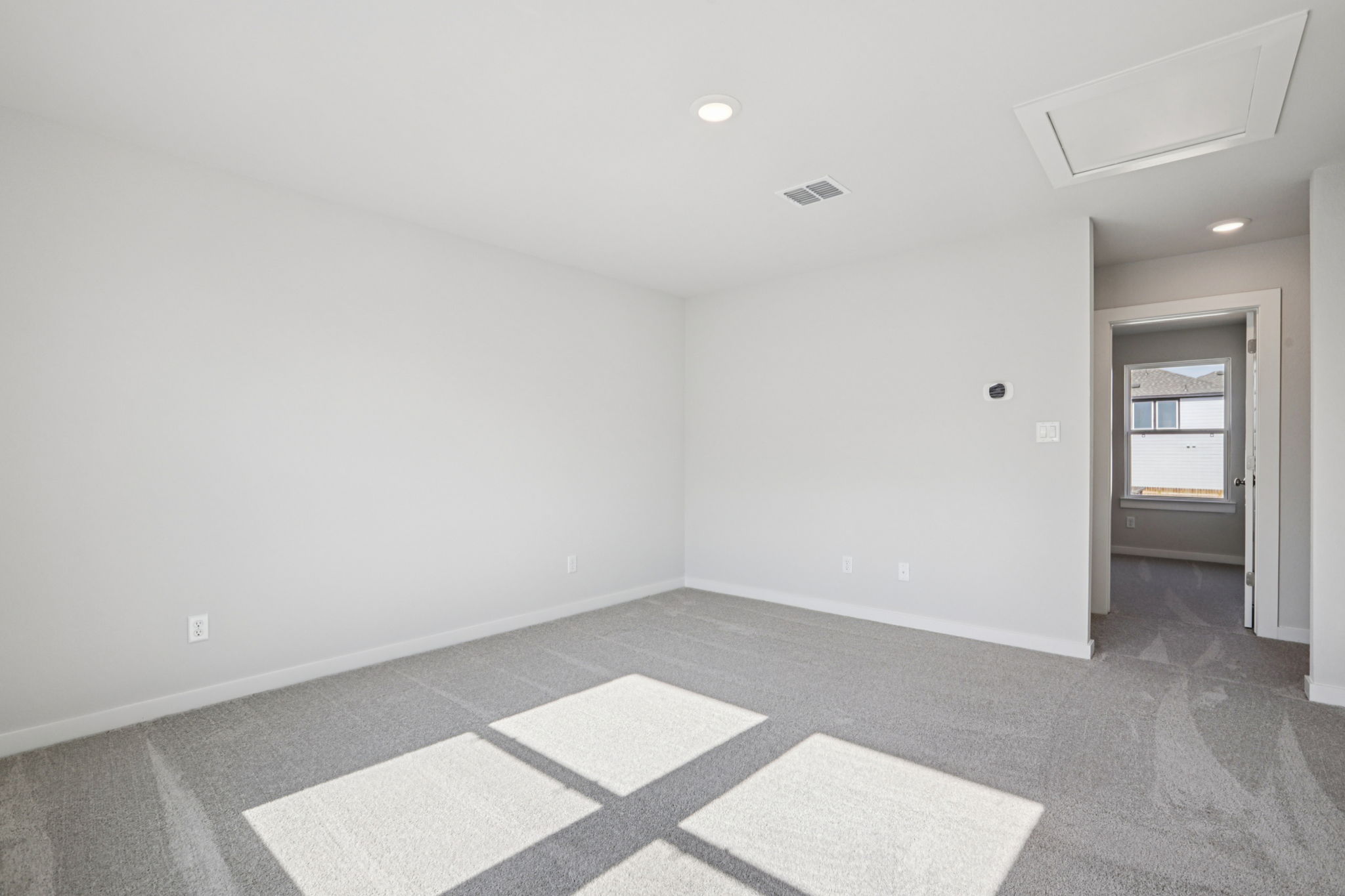 A room with a tile floor and a door.