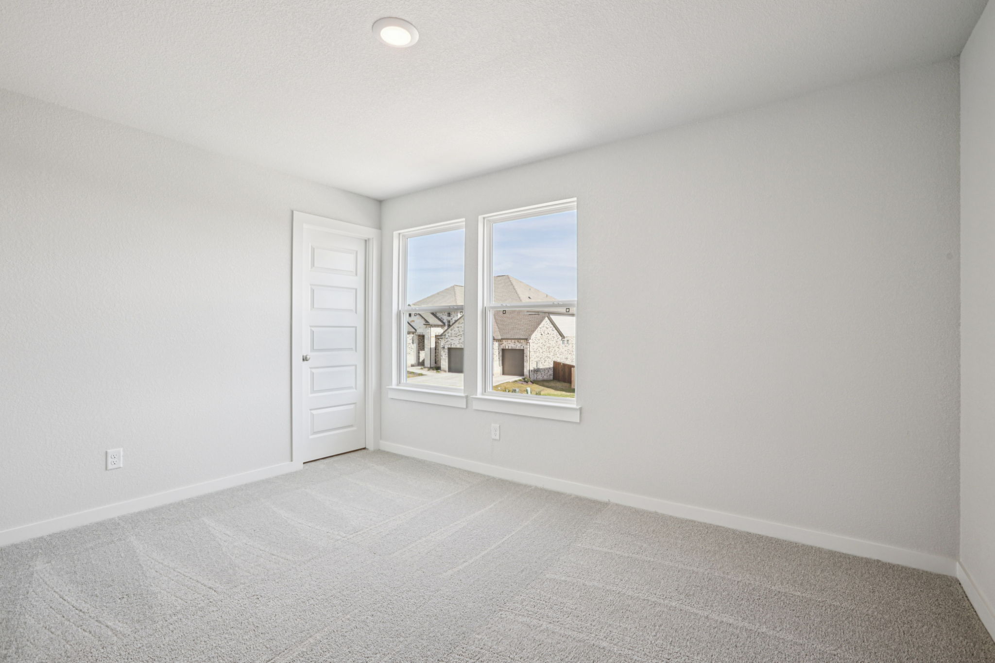 A room with a window and a door.