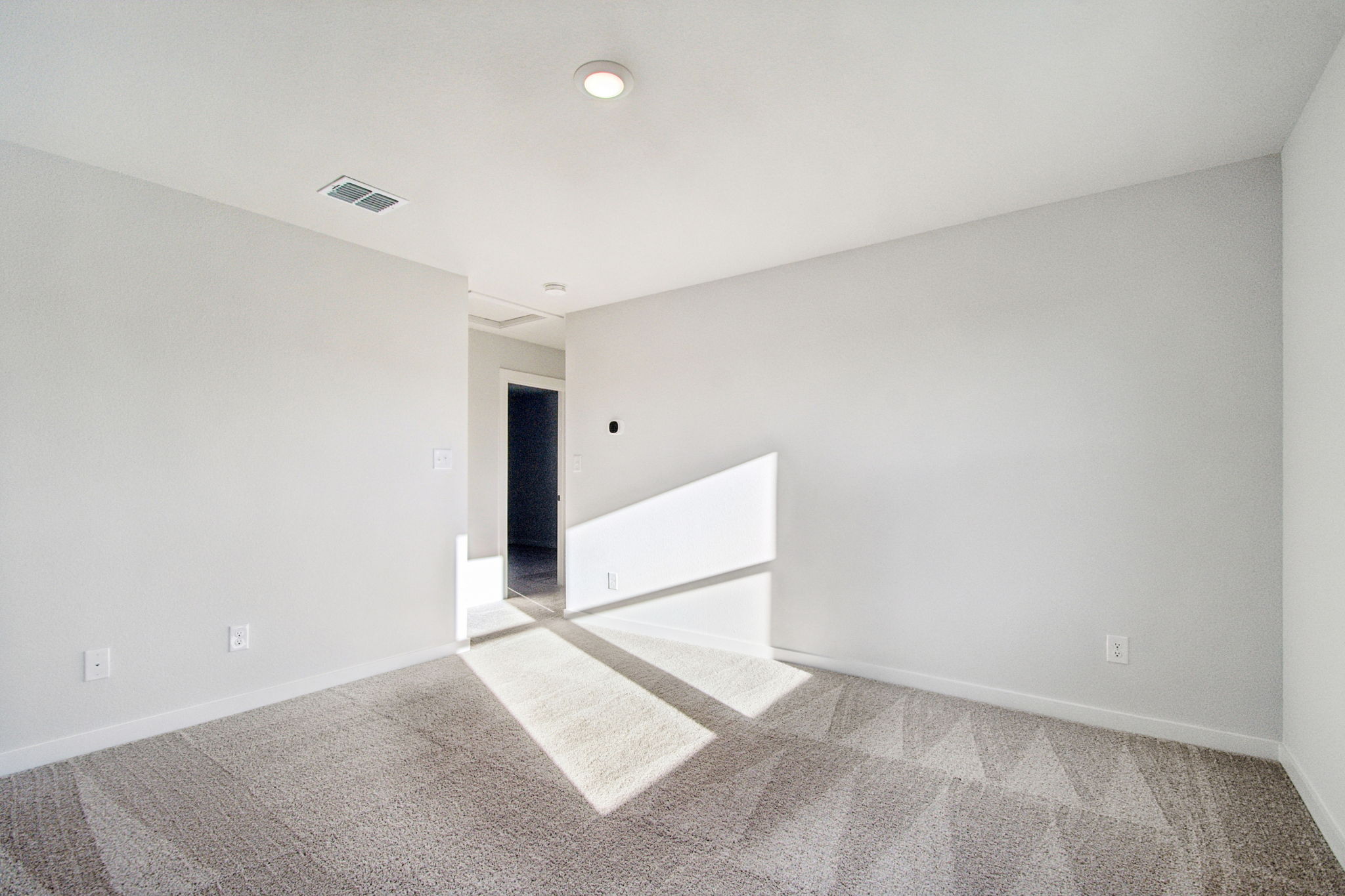 A hallway with a rug.