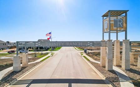 A road with a sign and flags.