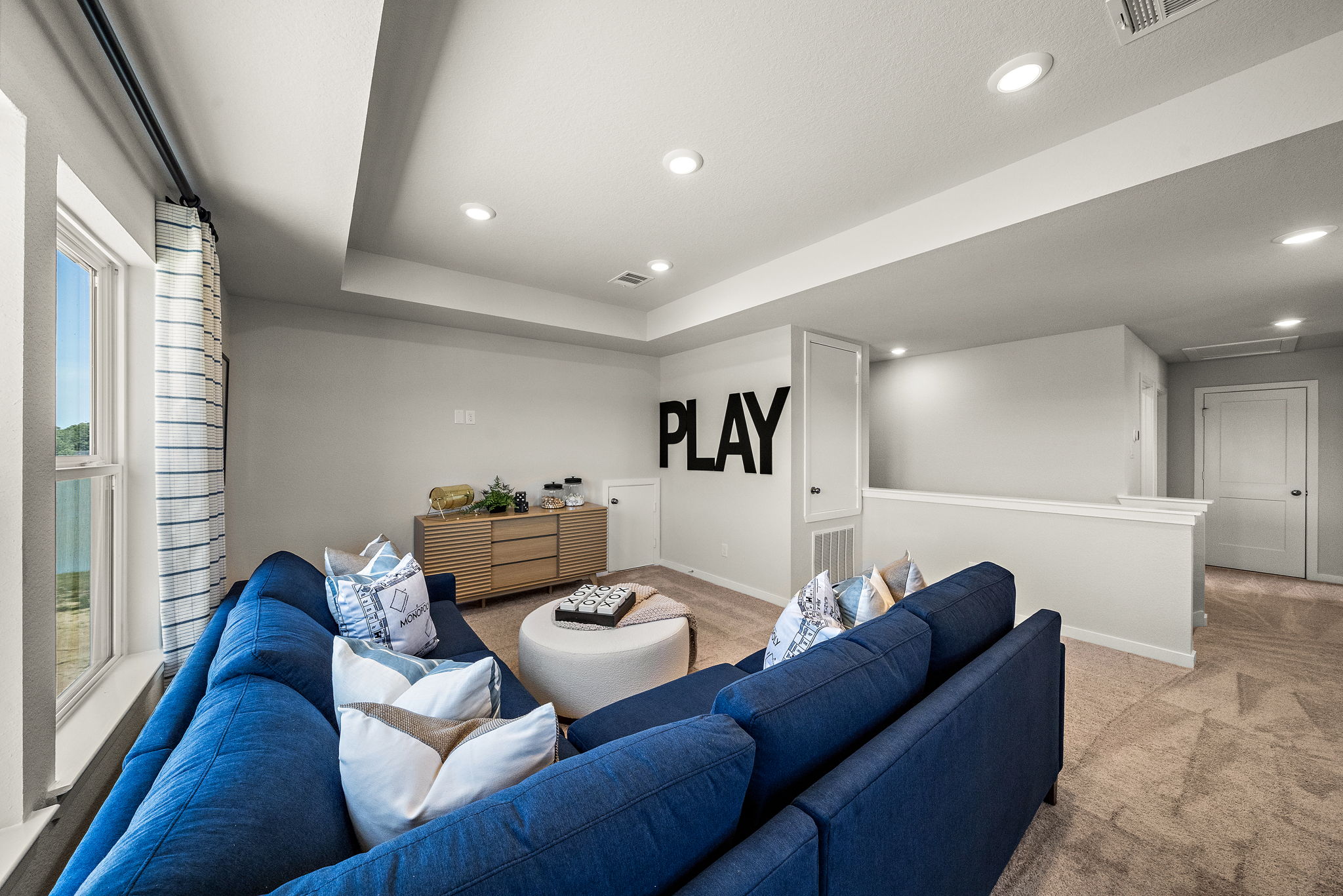 A living room with blue couches.