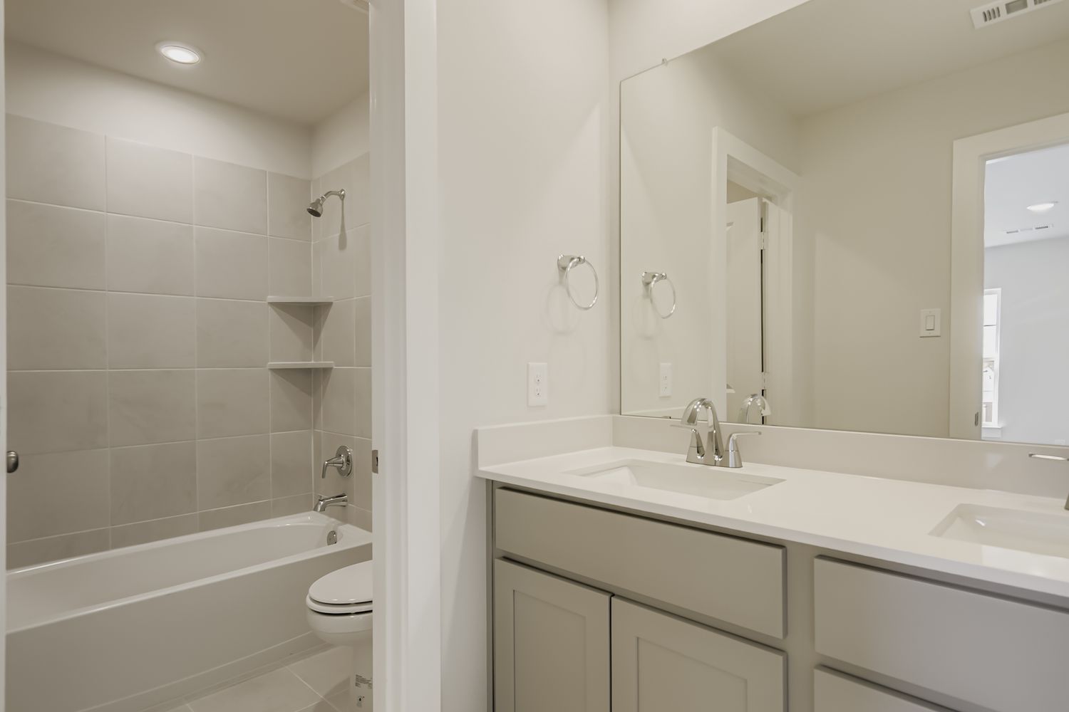 A bathroom with a tub sink and toilet.