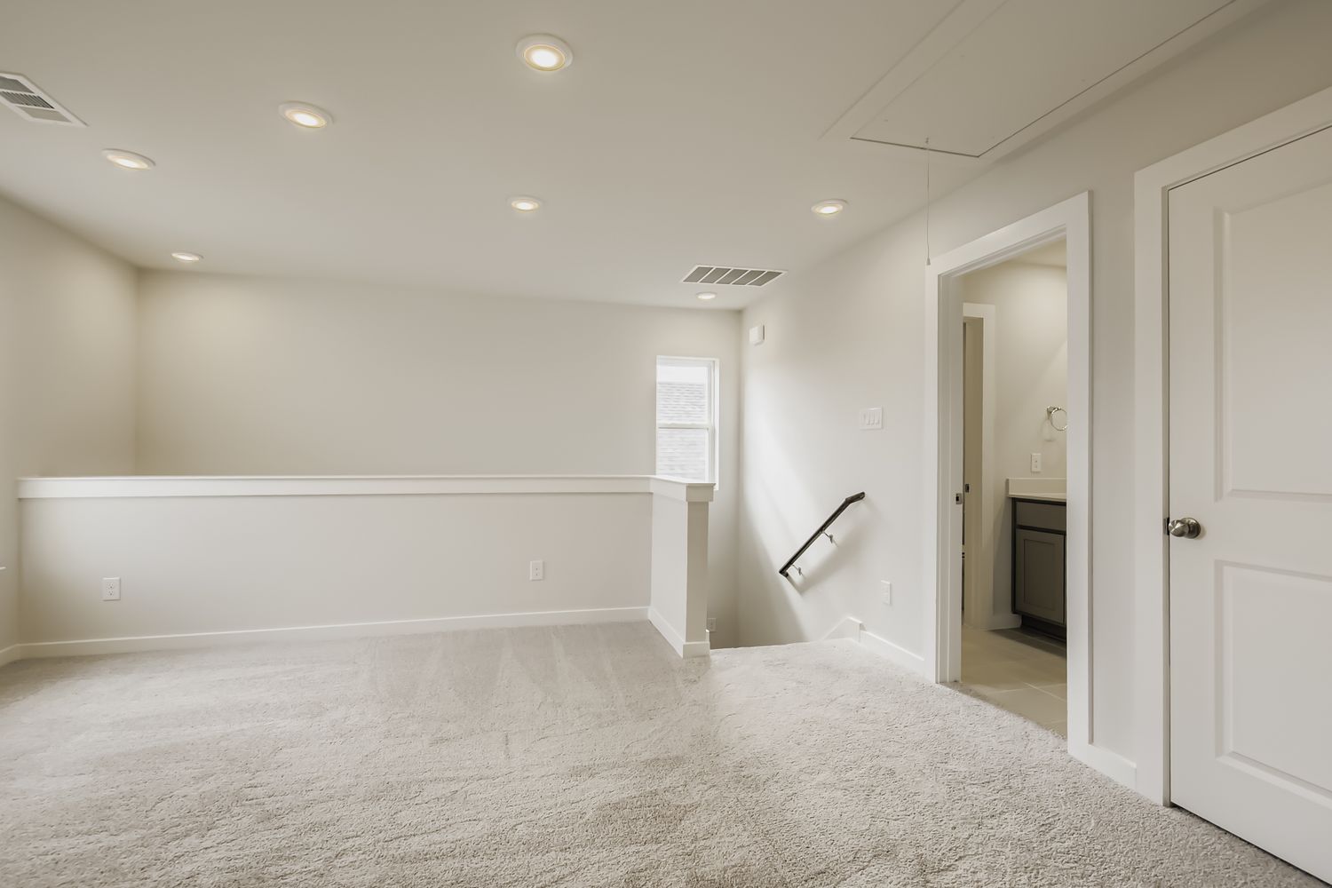A room with white walls and a white door.