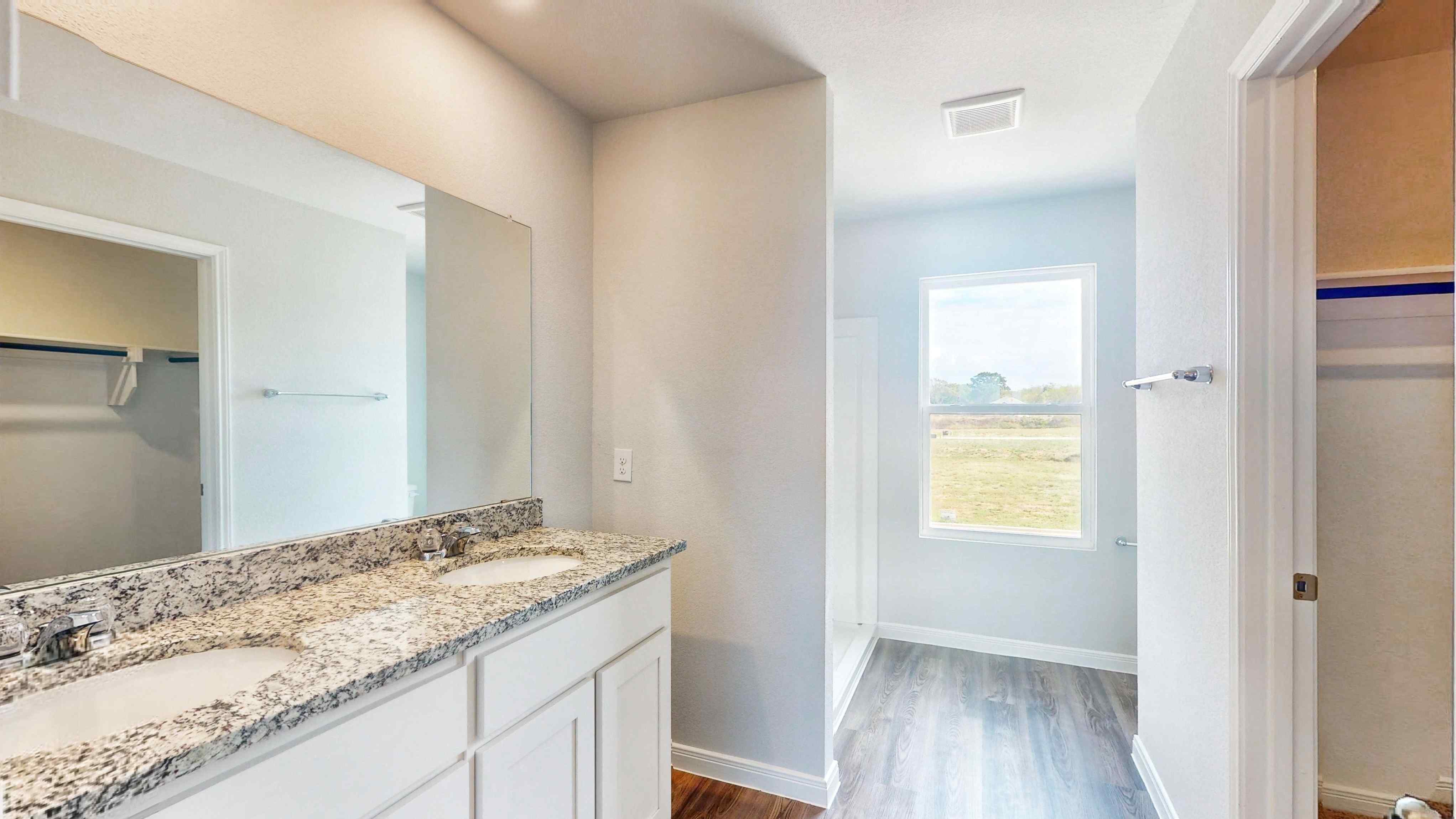 A bathroom with a marble countertop.