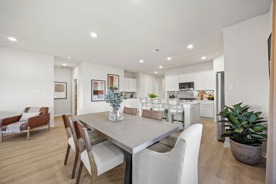A large kitchen with a dining table.