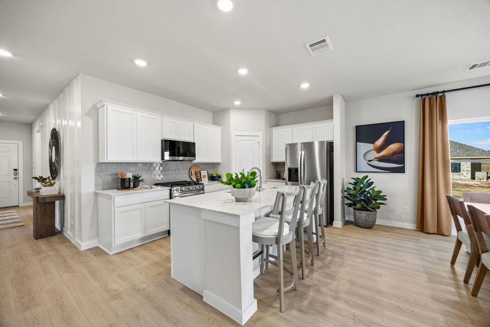 A kitchen with white cabinets.