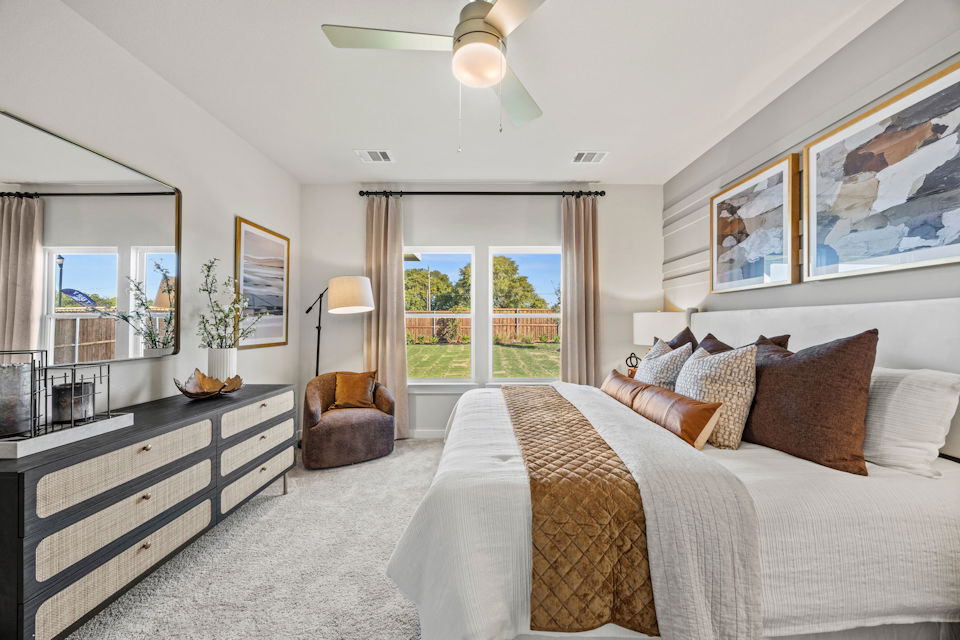 A bedroom with a large window.