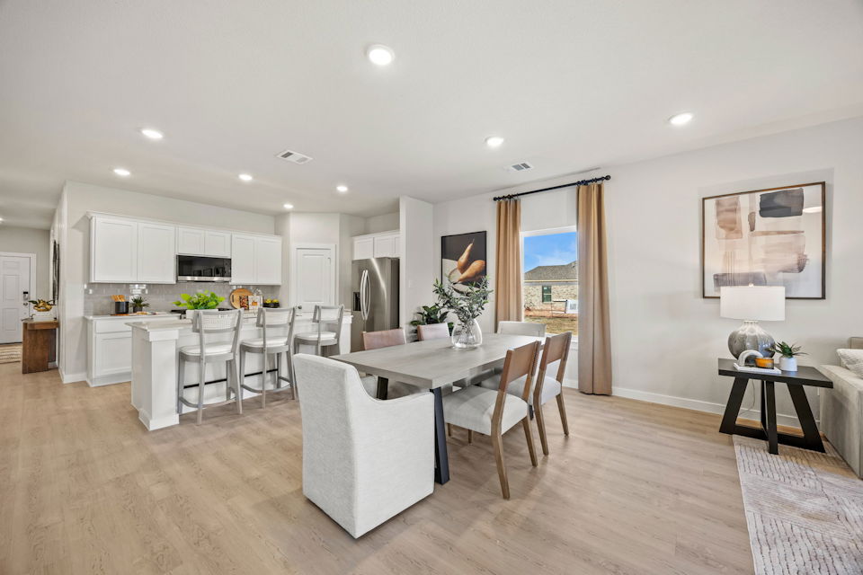 A large kitchen with a dining table.