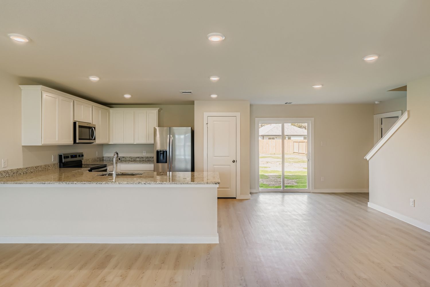 A kitchen with white cabinets.