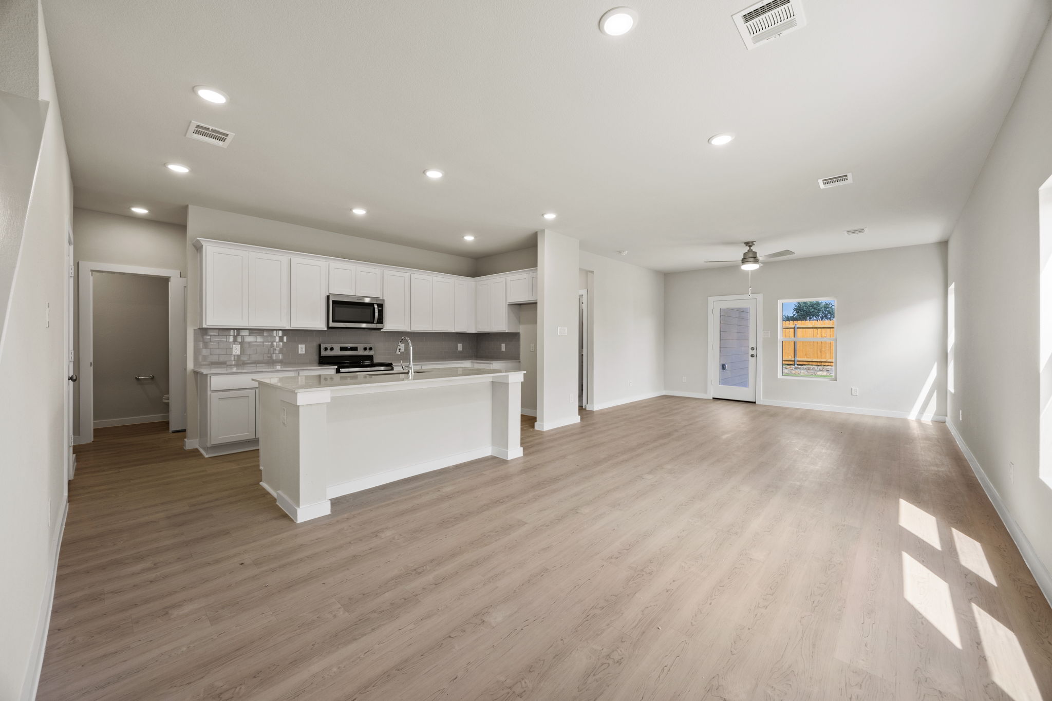 A large kitchen with white cabinets.