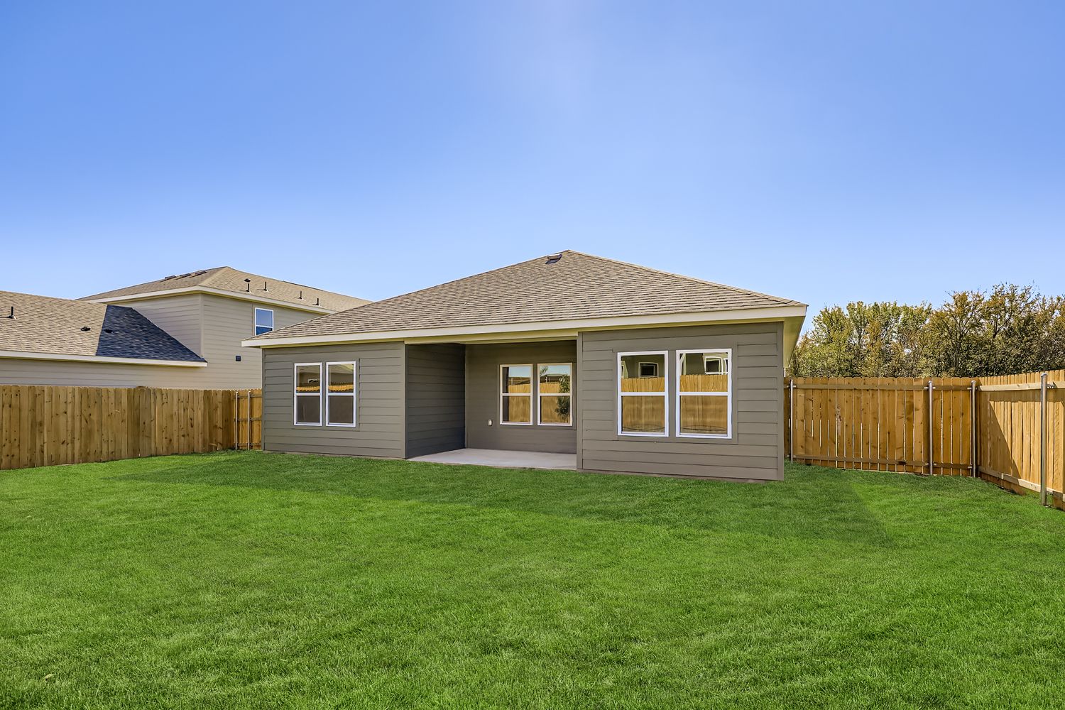 A house with a fence and grass.