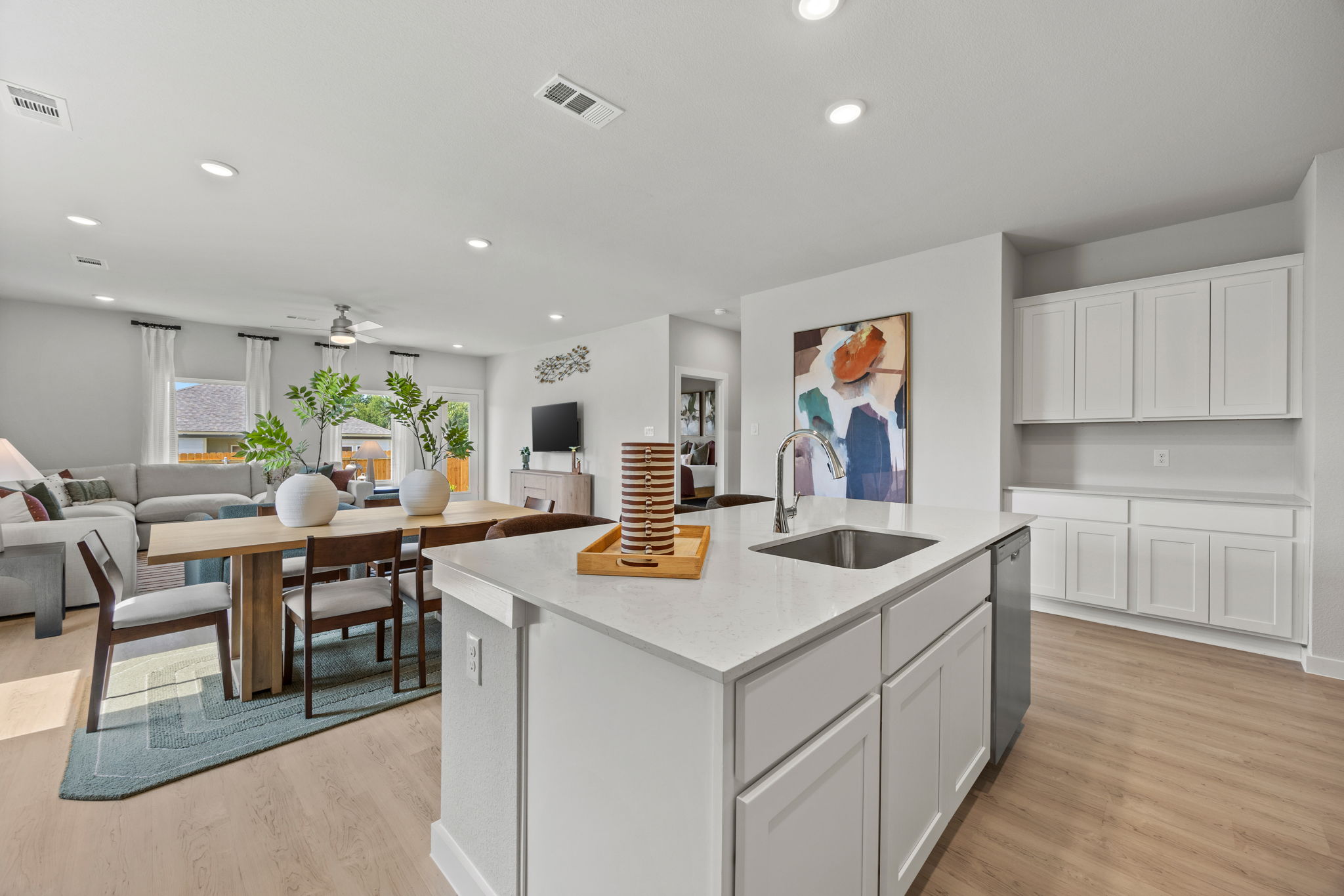 A kitchen with a dining table and a sink.