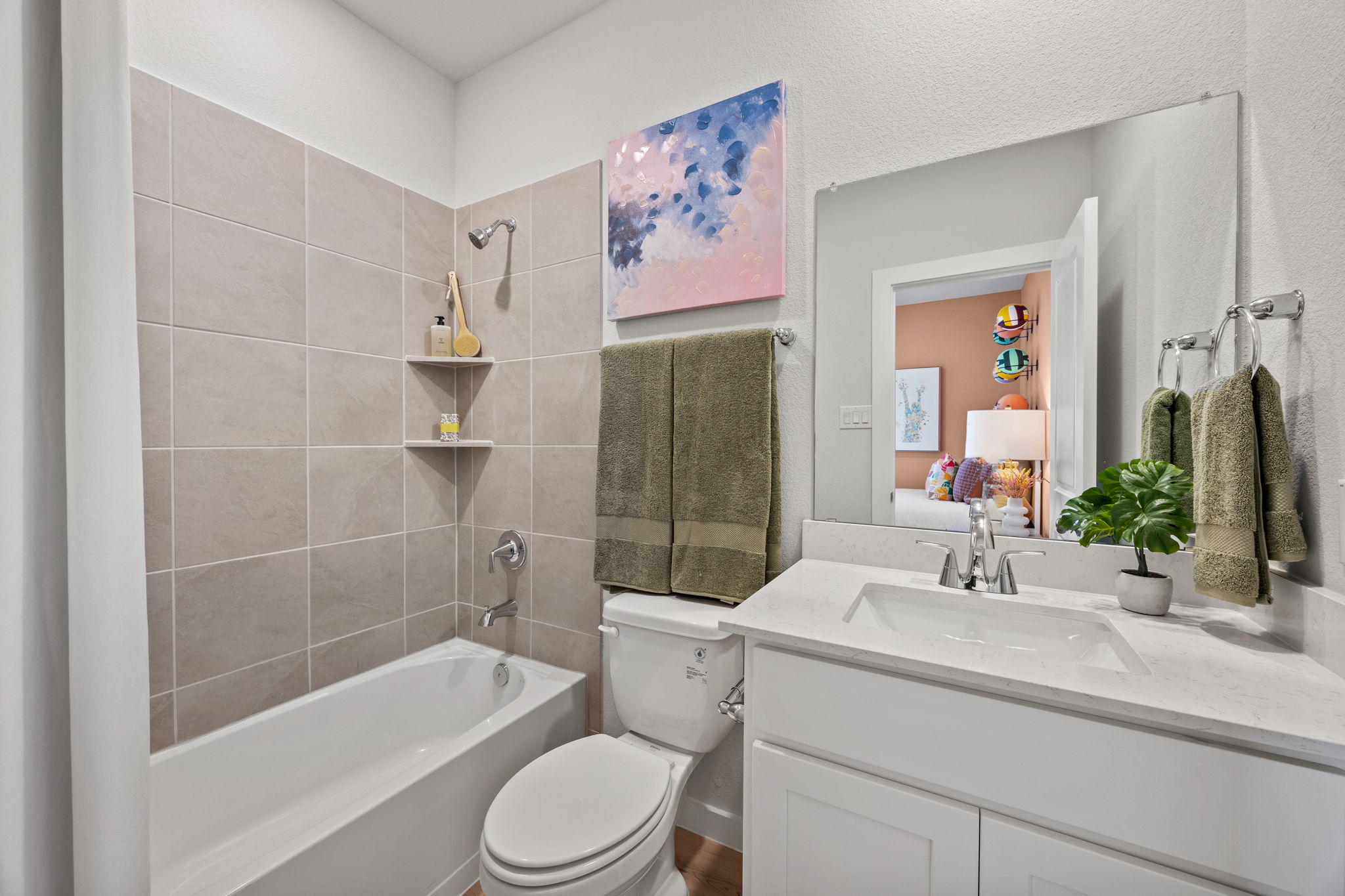 A bathroom with a tub toilet and sink.