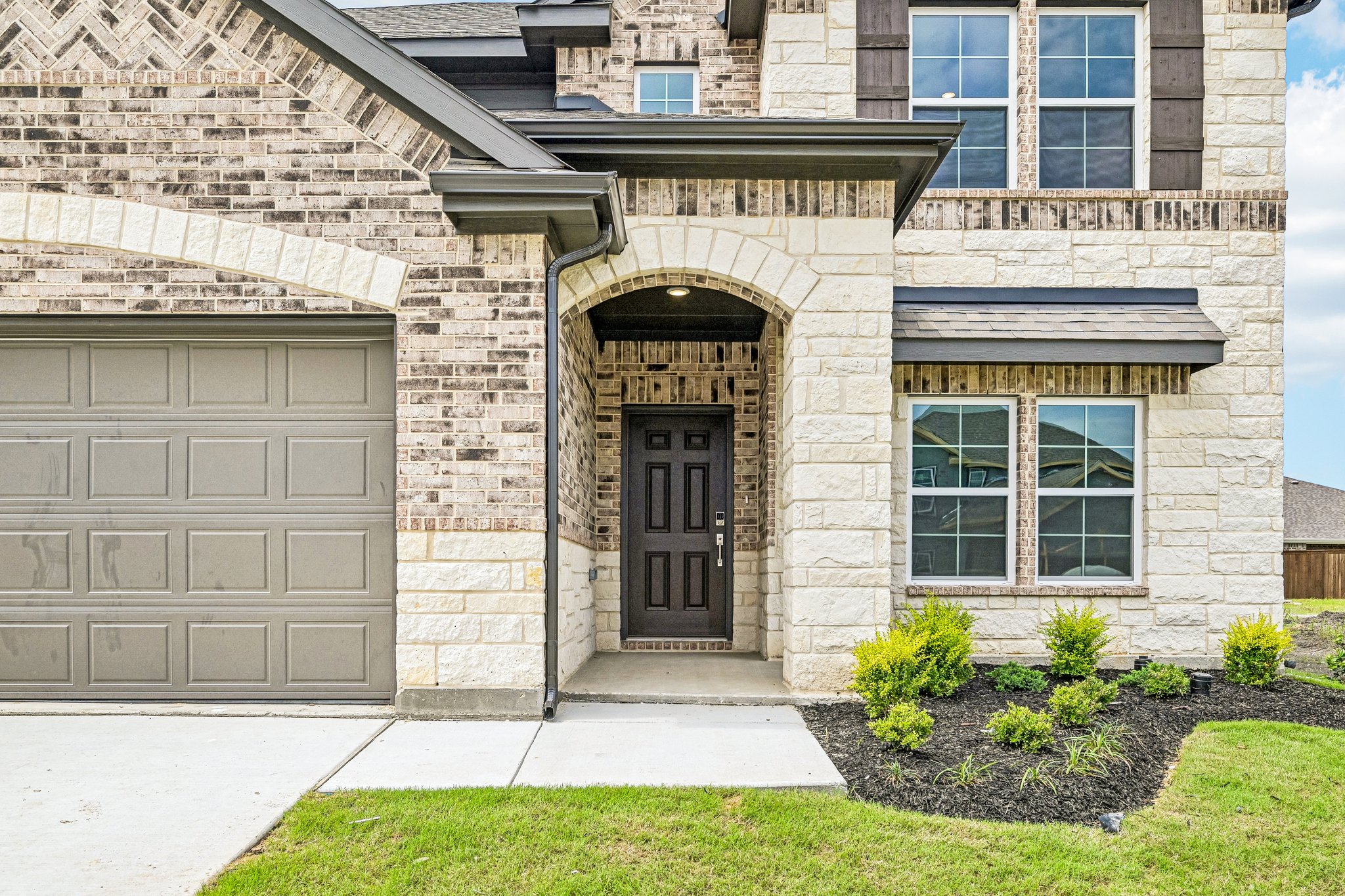 A stone building with a black door.