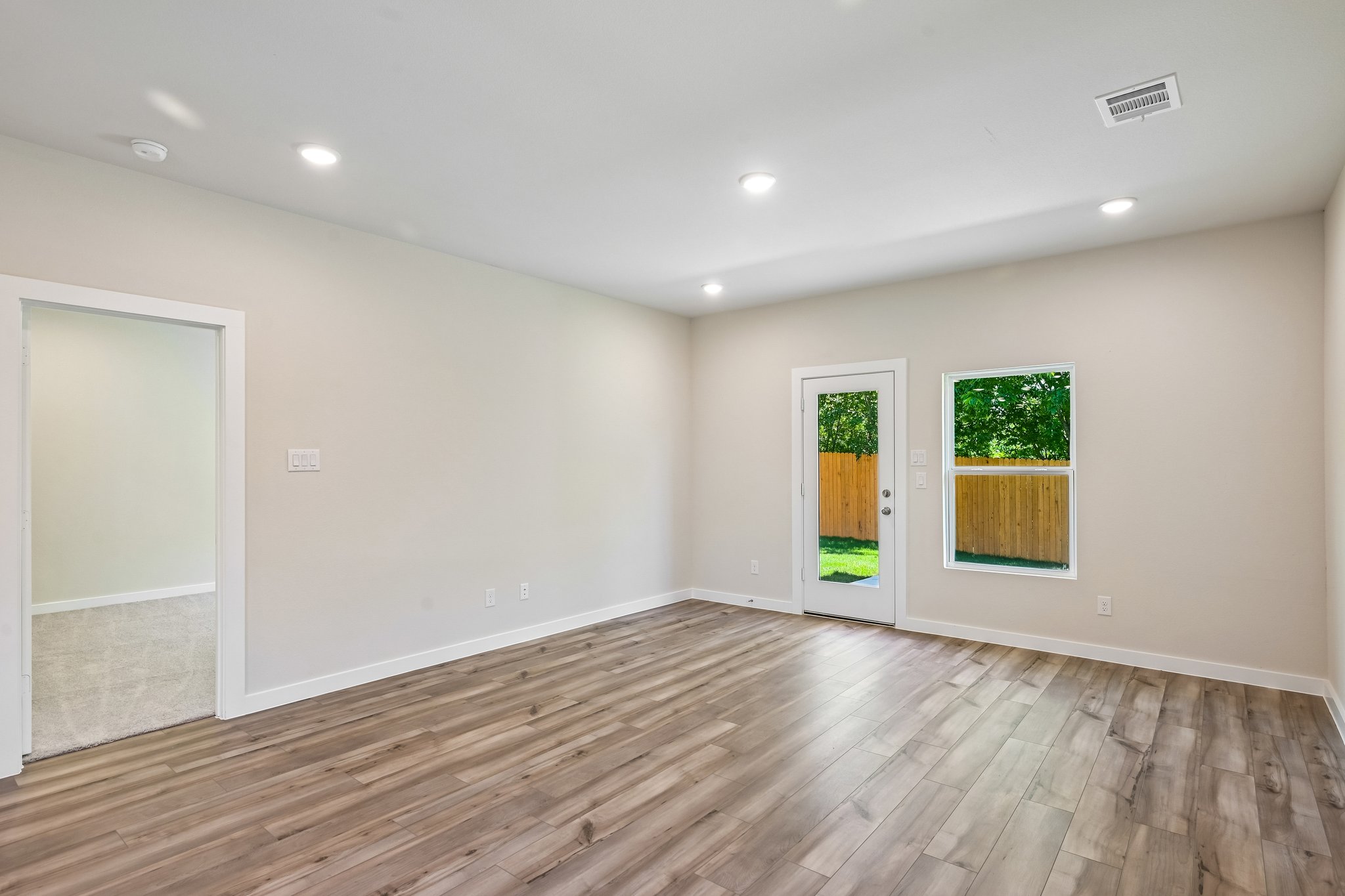 A room with a wood floor and a wood floor.