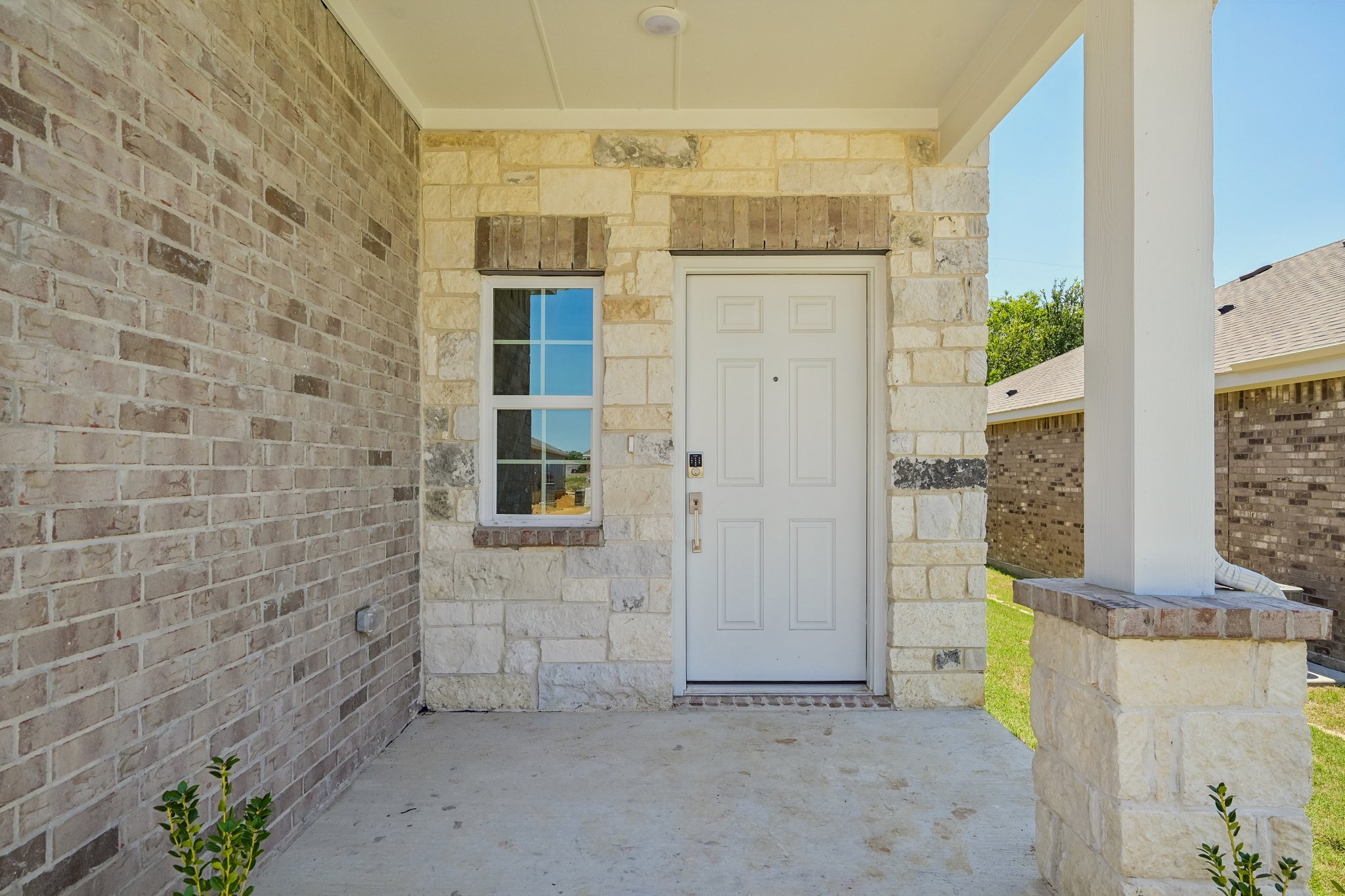 A white door in a stone building.