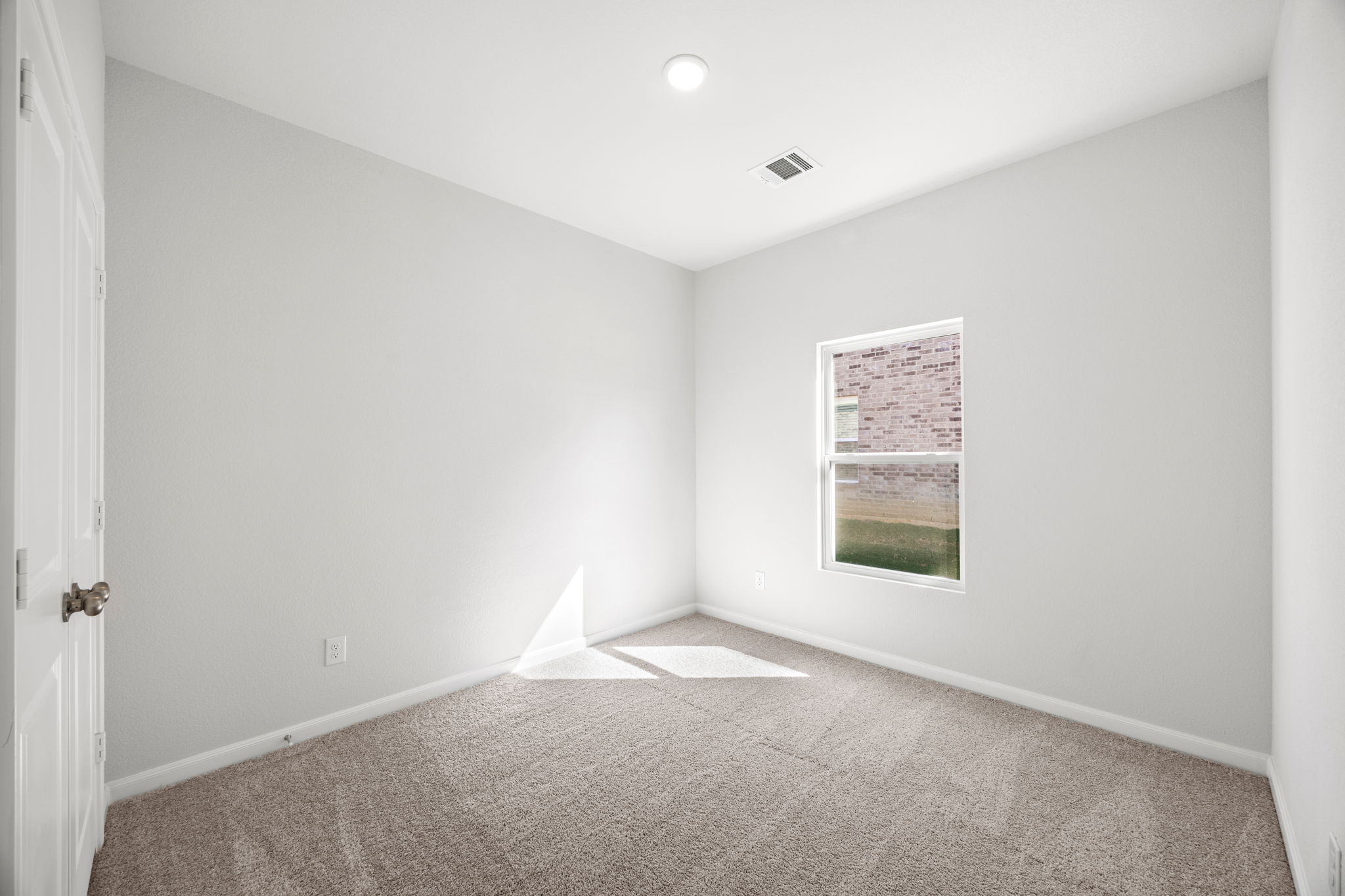 A room with a carpet and a poster on the wall.