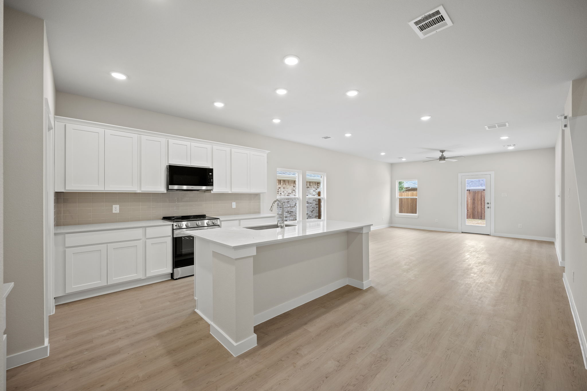 A kitchen with white cabinets.