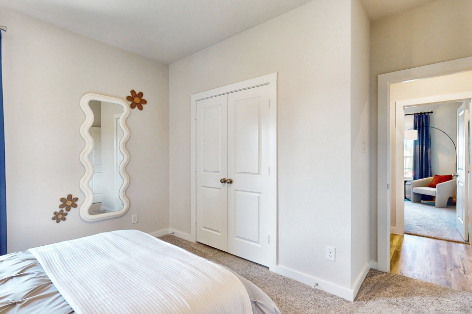 A bedroom with white doors.