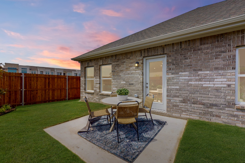 A patio with a table and chairs.