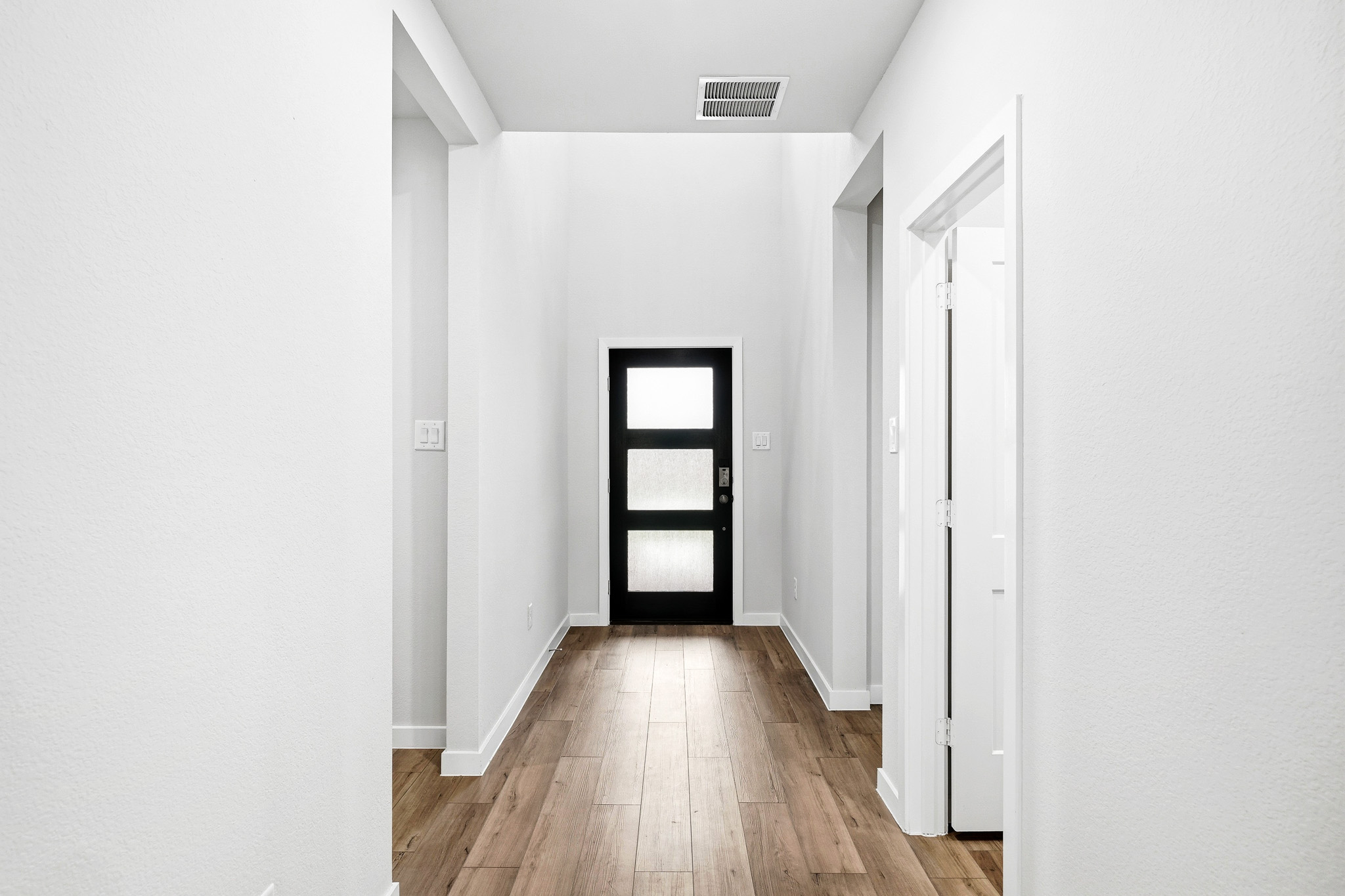 A hallway with white walls.