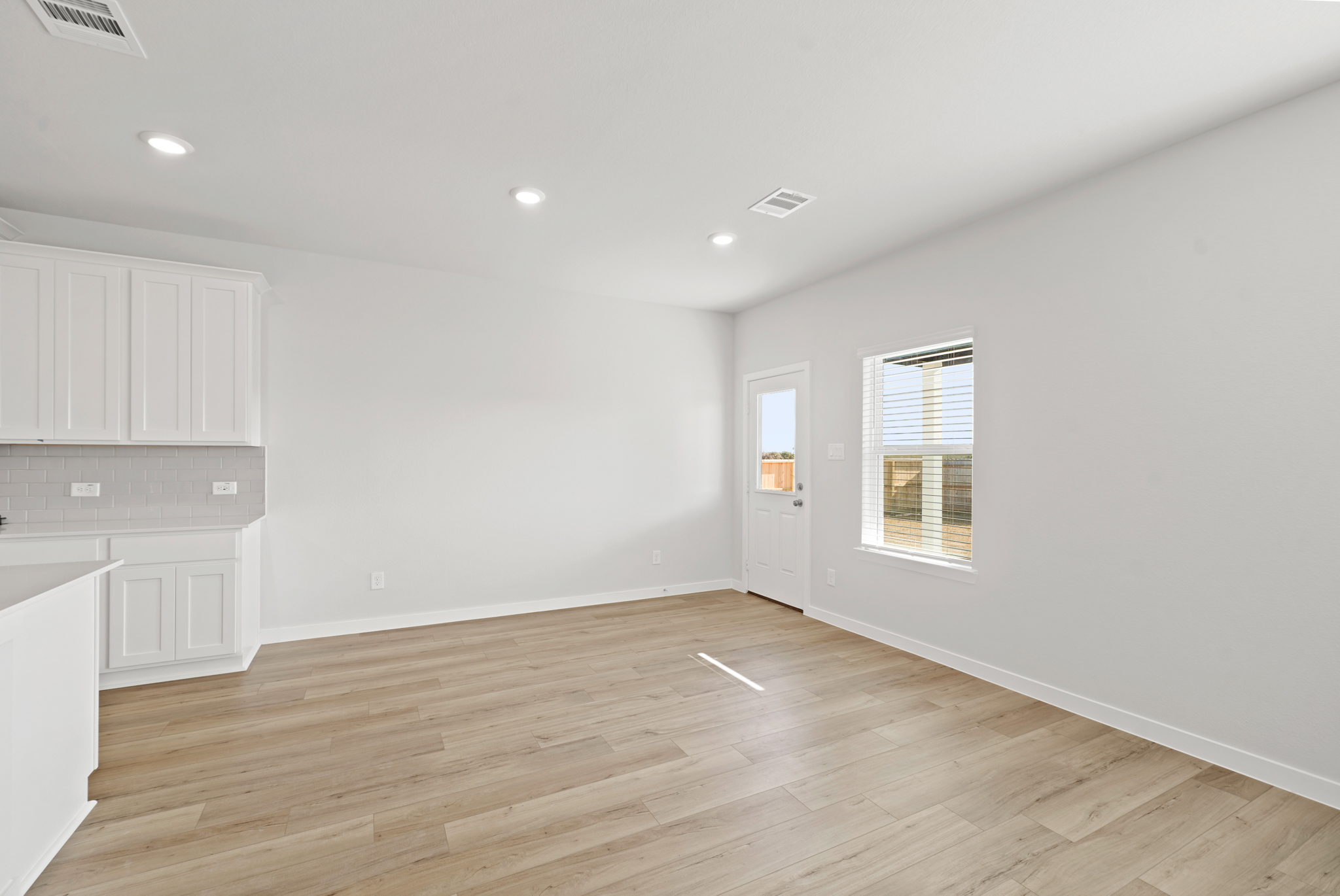 A room with white cabinets.