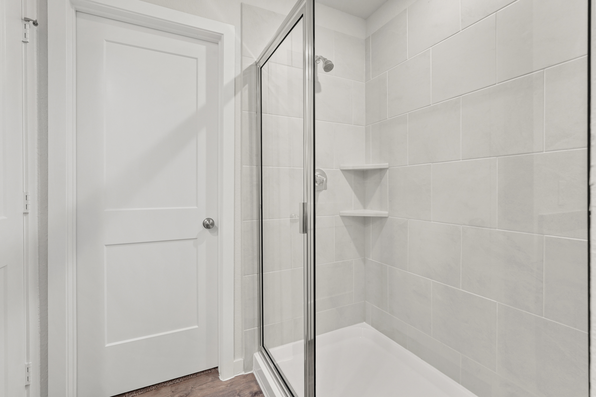 A shower with a glass door.