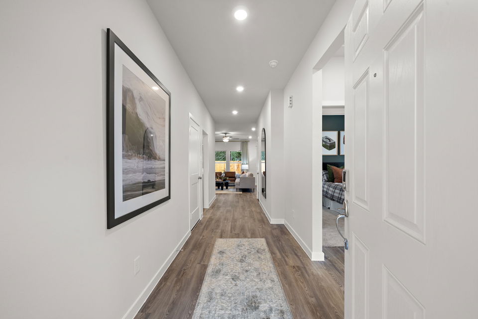 A hallway with white walls.