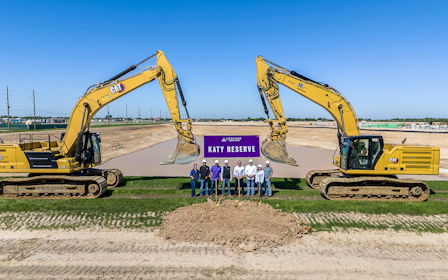 A group of people standing in front of a construction site.