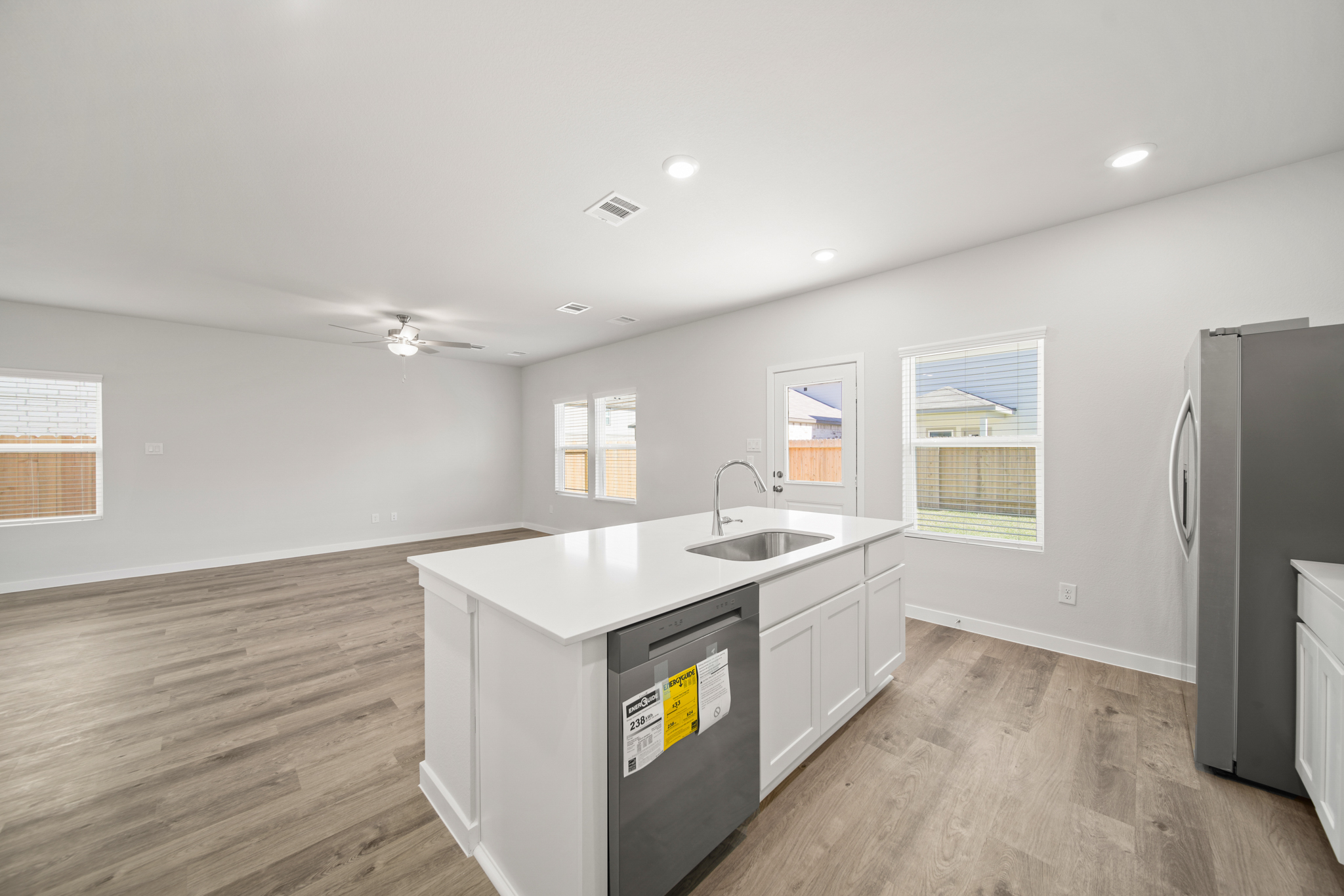 A kitchen with white cabinets.