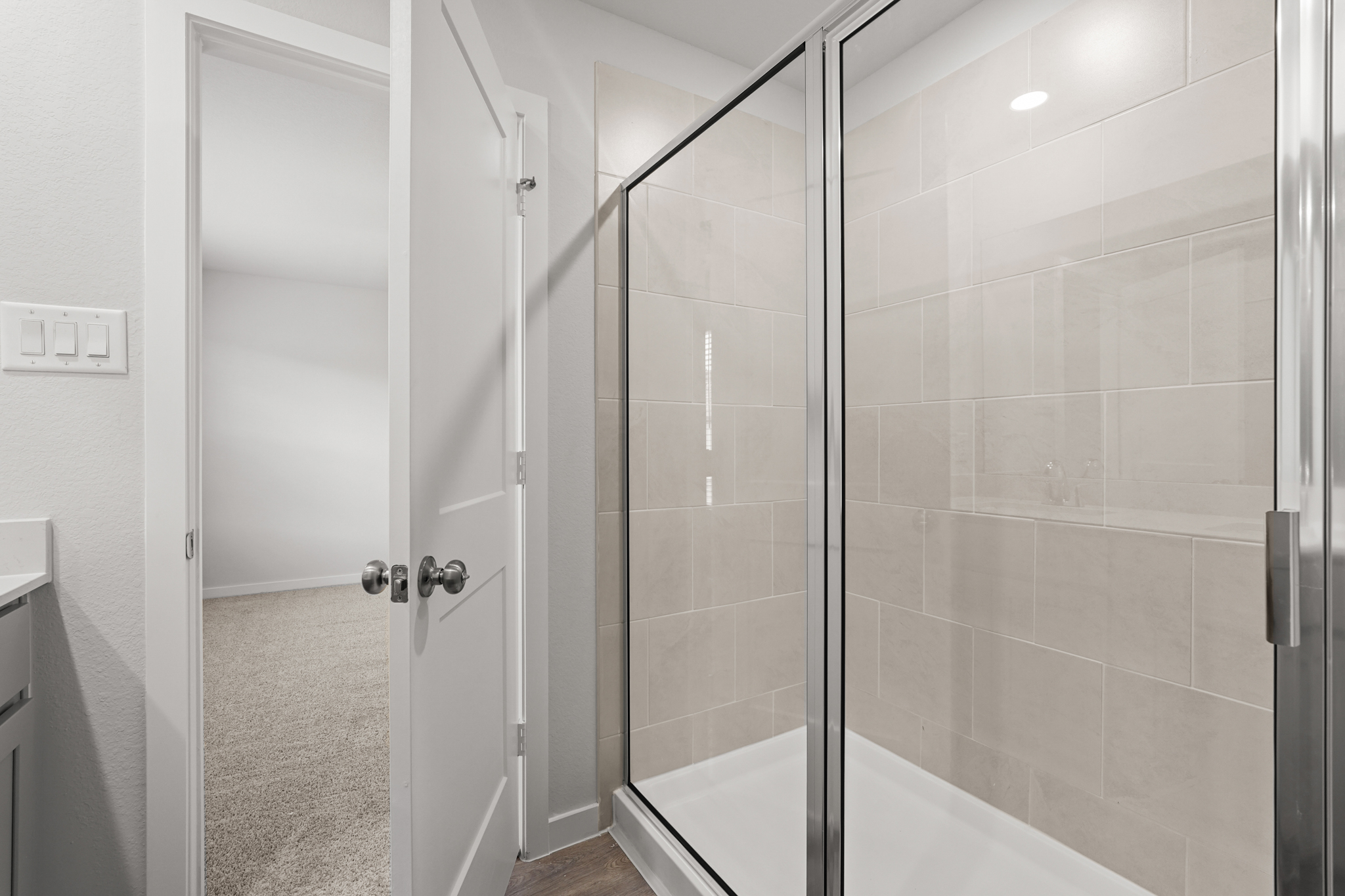 A bathroom with a glass shower.