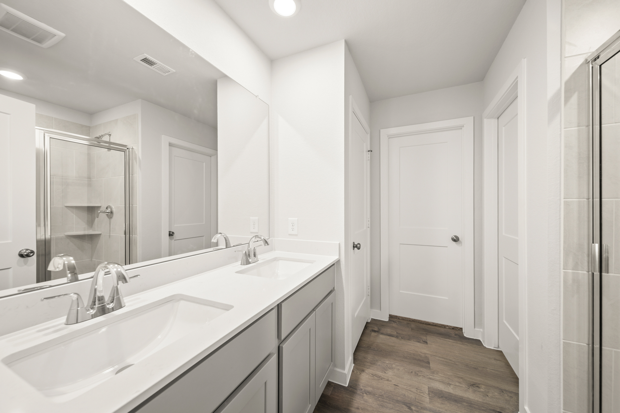 A bathroom with a large mirror.