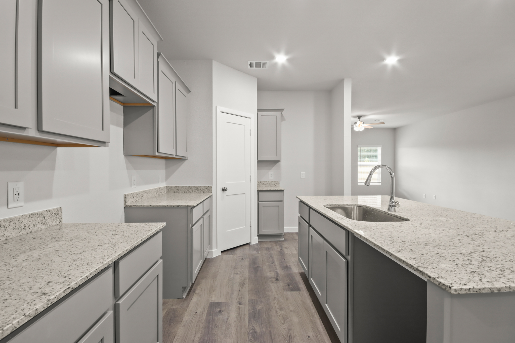 A kitchen with marble counters.