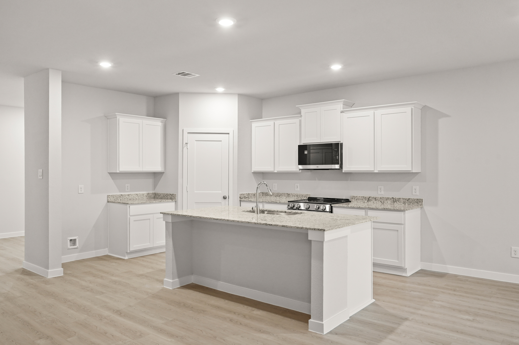 A kitchen with white cabinets.