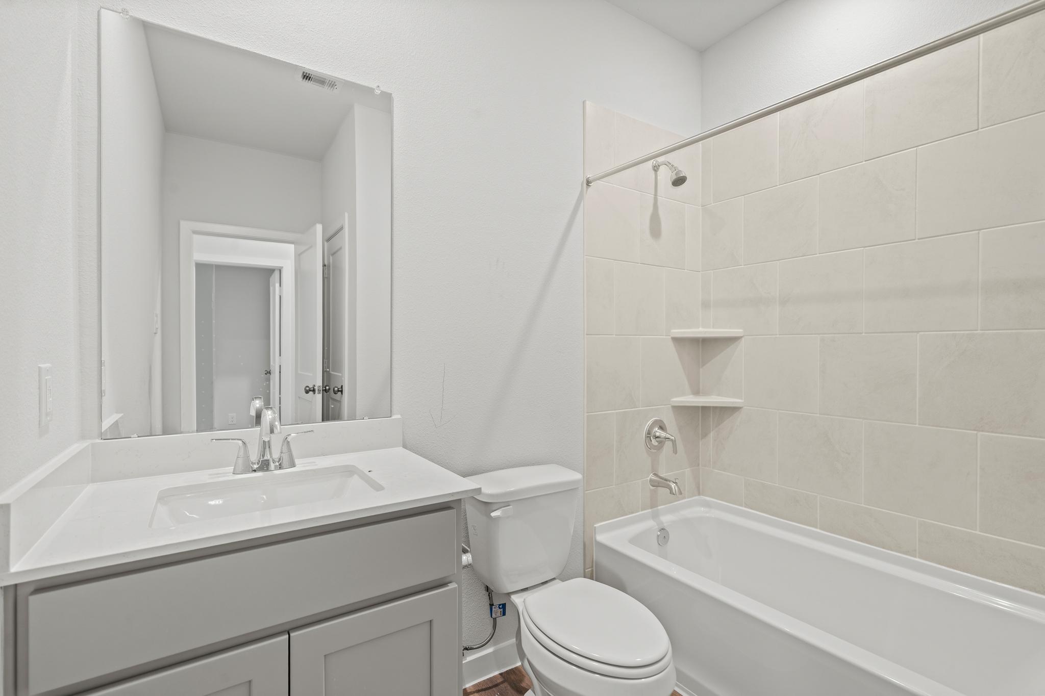 A bathroom with a tub sink and toilet.