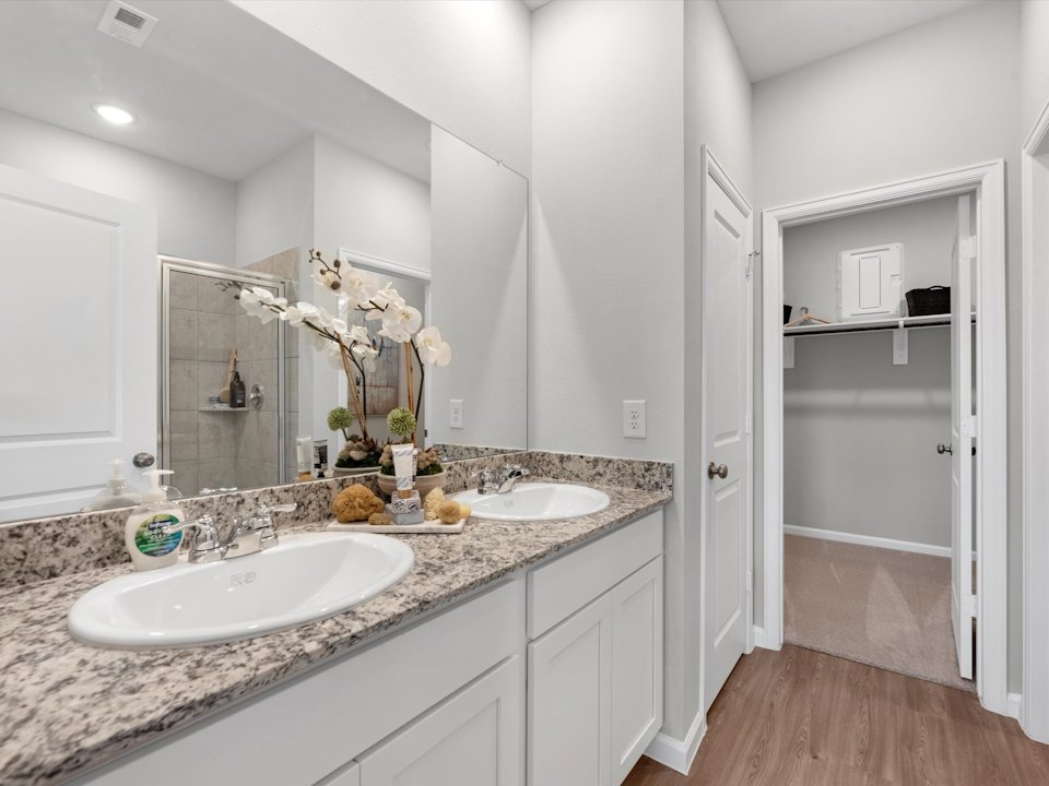 A bathroom with a large mirror.