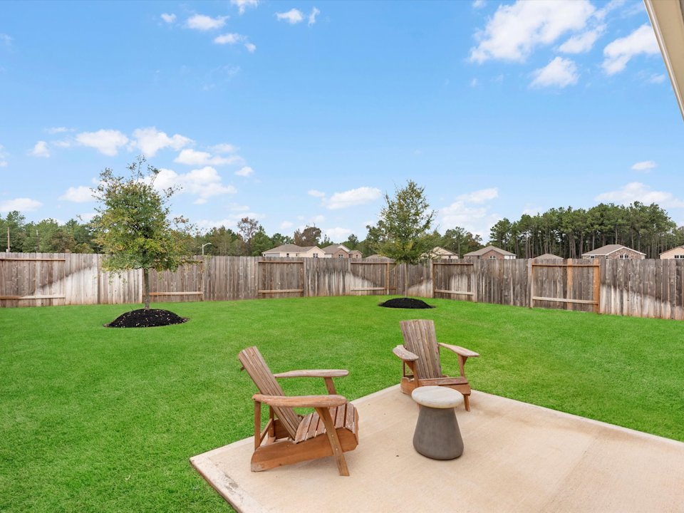 A couple of chairs on a patio.