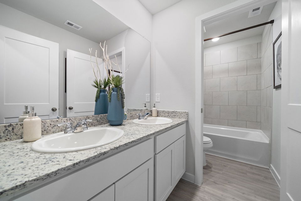 A bathroom with a large mirror.