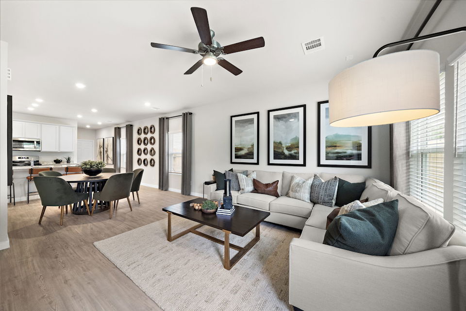 A living room with a ceiling fan.
