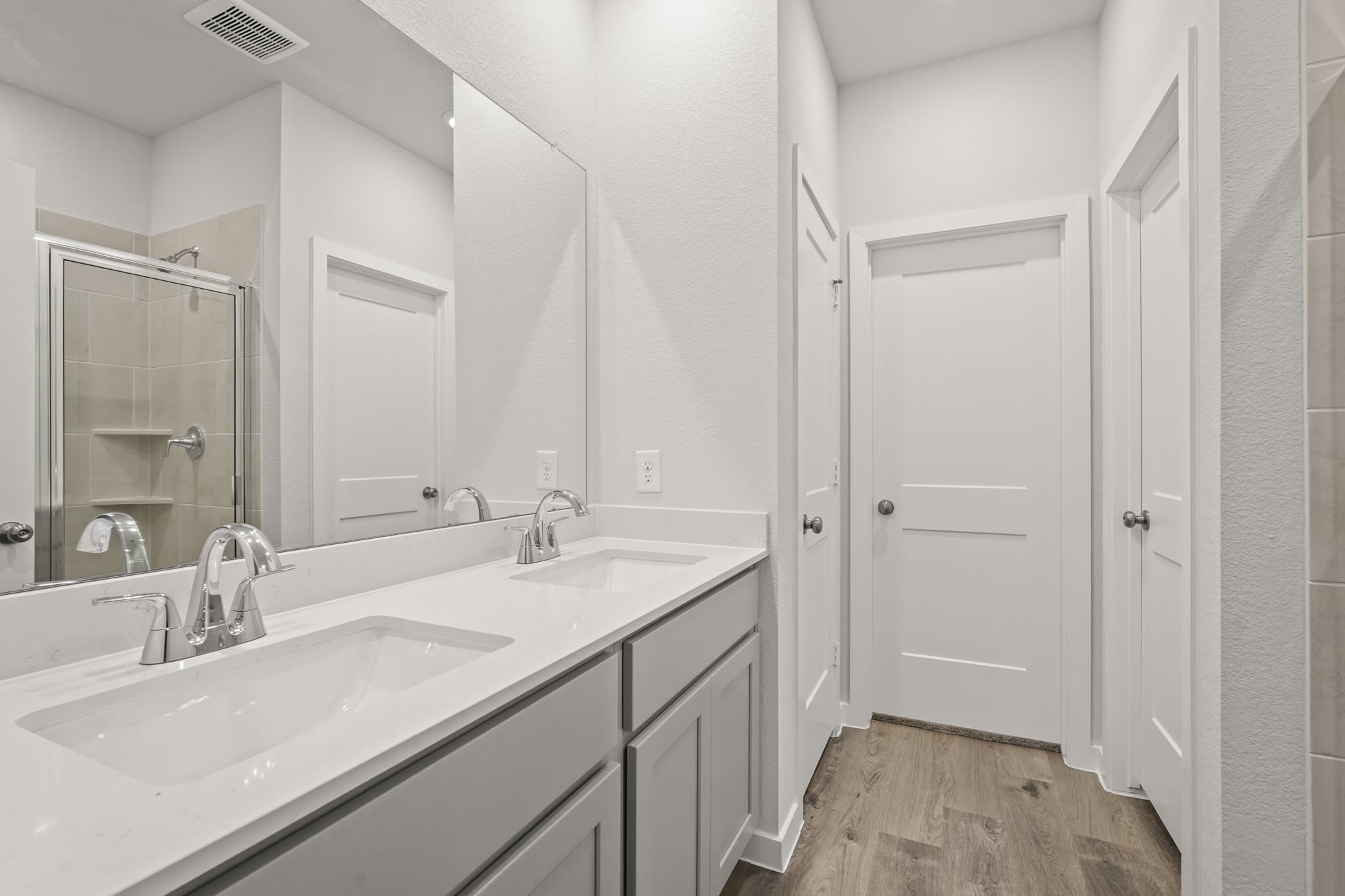 A bathroom with a large mirror.
