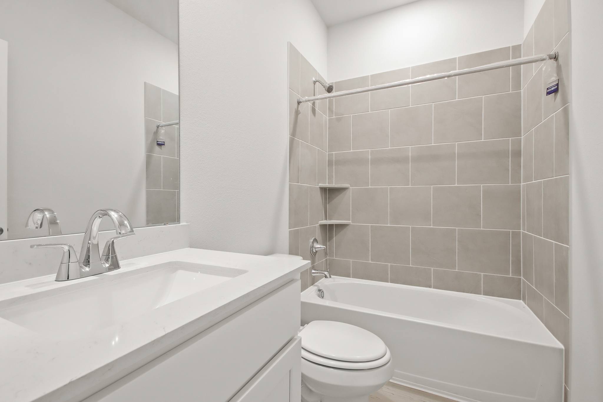 A bathroom with a tub sink and toilet.